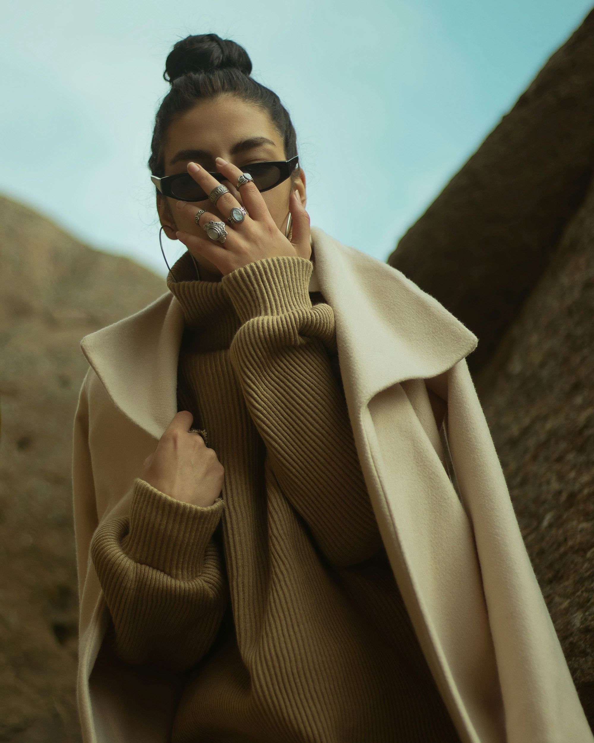 Model in a camel coat and ribbed knit